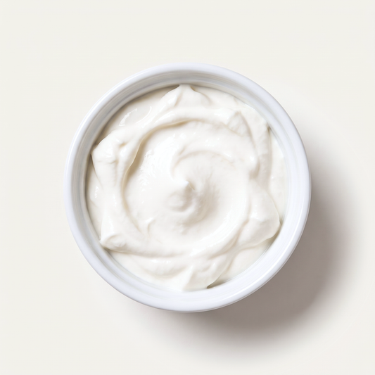 Probiotic vegan sour cream in a white ramekin, overhead